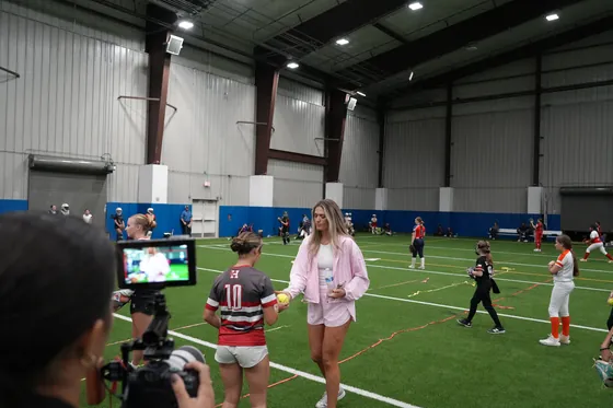 A coach handing a ball to a player
